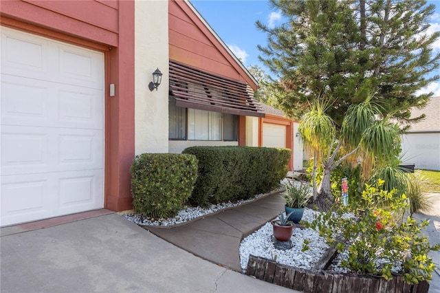 12234 Cider Mill Ln, Hudson, FL 34667 - property entrance with stucco siding and an attached garage