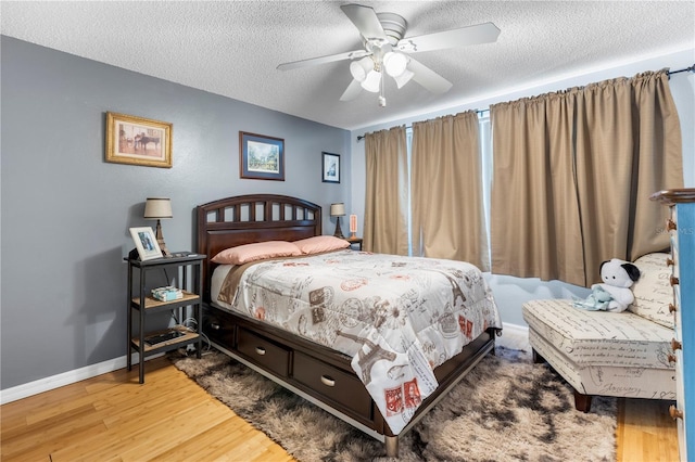 12234 Cider Mill Ln, Hudson, FL 34667 - bedroom featuring wood finished floors, a textured ceiling, and ceiling fan