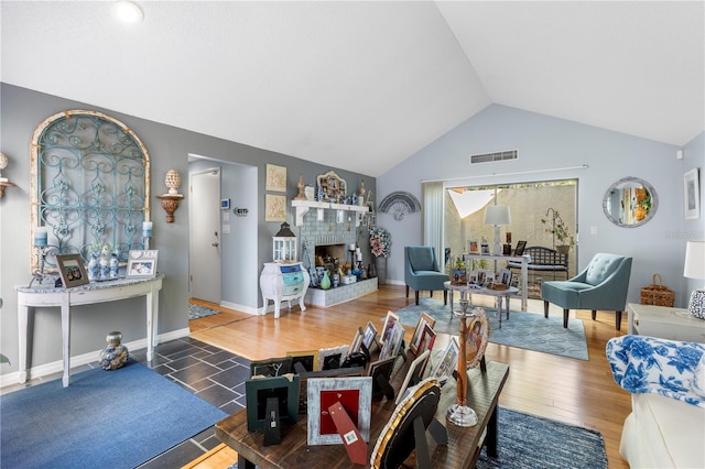 12234 Cider Mill Ln, Hudson, FL 34667 - living area featuring vaulted ceiling, wood finished floors, and a fireplace with raised hearth