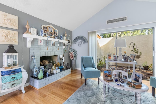12234 Cider Mill Ln, Hudson, FL 34667 - living room with a brick fireplace, wood finished floors, and high vaulted ceiling