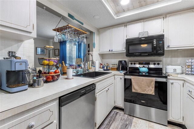 12234 Cider Mill Ln, Hudson, FL 34667 - kitchen featuring stainless steel appliances, light countertops, backsplash, a textured ceiling, and ornamental molding