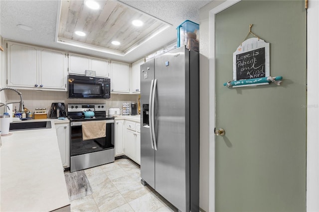 12234 Cider Mill Ln, Hudson, FL 34667 - kitchen with stainless steel appliances, a tray ceiling, light countertops, backsplash, and recessed lighting