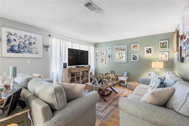 12234 Cider Mill Ln, Hudson, FL 34667 - living room with light wood-style floors and a textured ceiling