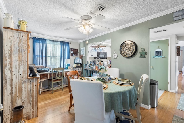 12234 Cider Mill Ln, Hudson, FL 34667 - dining space with hardwood / wood-style flooring, ceiling fan, ornamental molding, and a textured ceiling