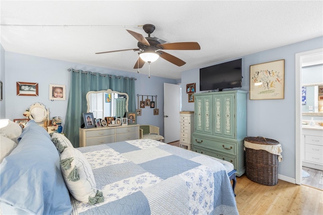12234 Cider Mill Ln, Hudson, FL 34667 - bedroom featuring wood finished floors, connected bathroom, and ceiling fan