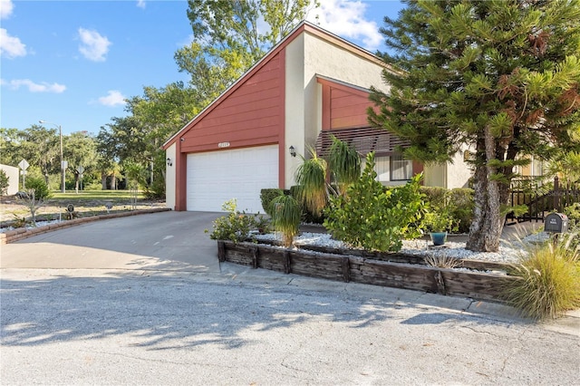 12234 Cider Mill Ln, Hudson, FL 34667 - view of front of property with stucco siding, a garage, and concrete driveway