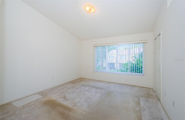 1241 Redondo Way, Wesley Chapel, FL 33543 - empty room featuring vaulted ceiling and carpet