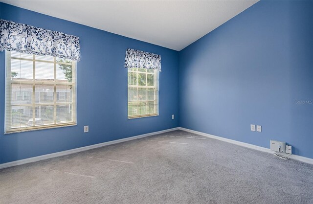 1241 Redondo Way, Wesley Chapel, FL 33543 - carpeted empty room featuring plenty of natural light and vaulted ceiling
