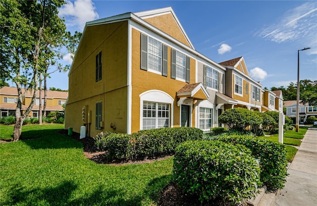 1241 Redondo Way, Wesley Chapel, FL 33543 - view of front facade with stucco siding, a front lawn, and a residential view