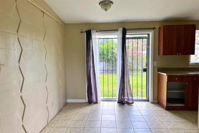 5016 S 86th St, Tampa, FL 33619 - entryway featuring light tile patterned flooring and concrete block wall