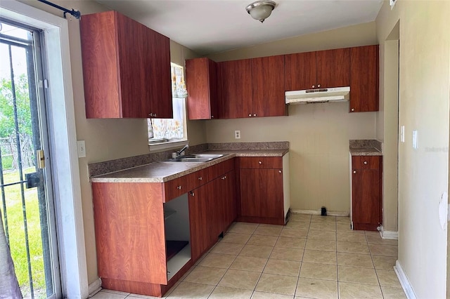5016 S 86th St, Tampa, FL 33619 - kitchen featuring under cabinet range hood and light tile patterned flooring
