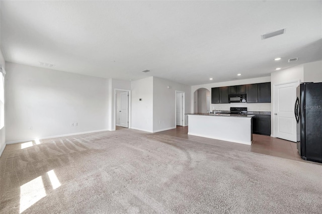 30732 Summer Sun Loop, Wesley Chapel, FL 33545 - unfurnished living room with arched walkways, recessed lighting, and light carpet