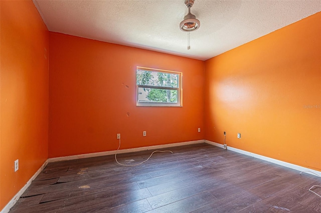 739 Chesapeake Dr, Tarpon Springs, FL 34689 - empty room with dark wood-type flooring and a textured ceiling