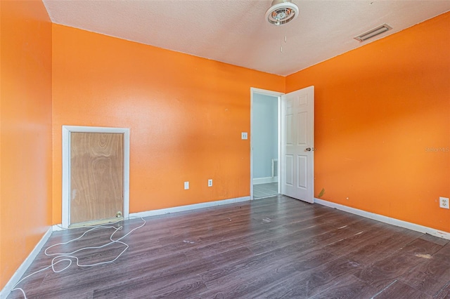 739 Chesapeake Dr, Tarpon Springs, FL 34689 - spare room with wood finished floors and a textured ceiling