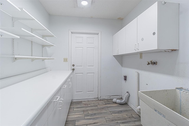 739 Chesapeake Dr, Tarpon Springs, FL 34689 - laundry area with wood finished floors and cabinet space