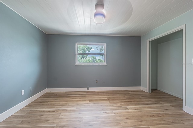 739 Chesapeake Dr, Tarpon Springs, FL 34689 - unfurnished bedroom featuring light wood-style flooring and wood ceiling