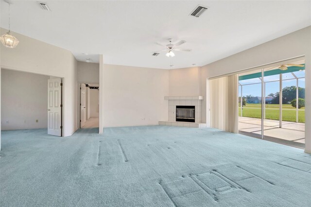 11908 Pilot Country Dr, Spring Hill, FL 34610 - unfurnished living room featuring ceiling fan, carpet floors, and a fireplace