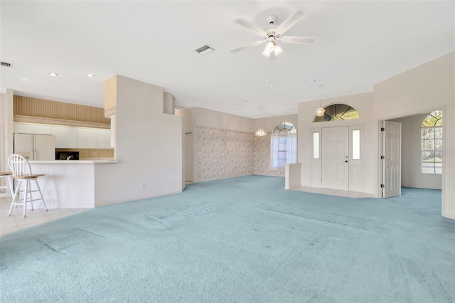 11908 Pilot Country Dr, Spring Hill, FL 34610 - unfurnished living room with light colored carpet, plenty of natural light, ceiling fan, and recessed lighting