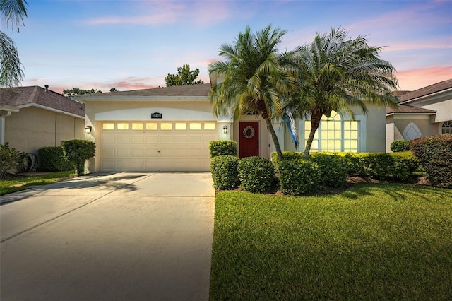 10409 Glen Willow Ln, Tampa, FL 33647 - view of front of home featuring stucco siding, a garage, driveway, and a lawn