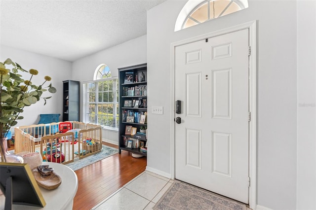 10409 Glen Willow Ln, Tampa, FL 33647 - entrance foyer featuring a textured ceiling and light tile patterned flooring
