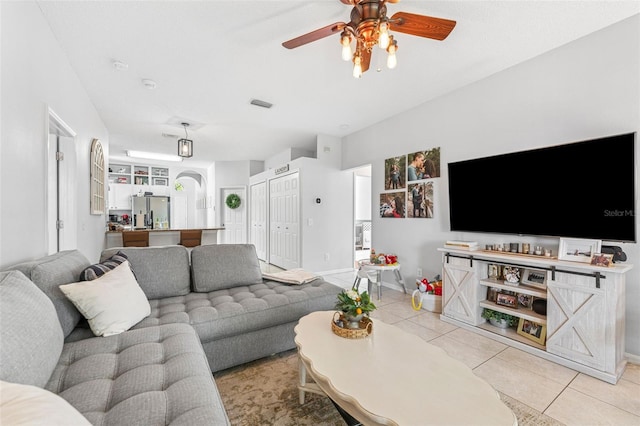 10409 Glen Willow Ln, Tampa, FL 33647 - living room featuring ceiling fan, light tile patterned flooring, and arched walkways