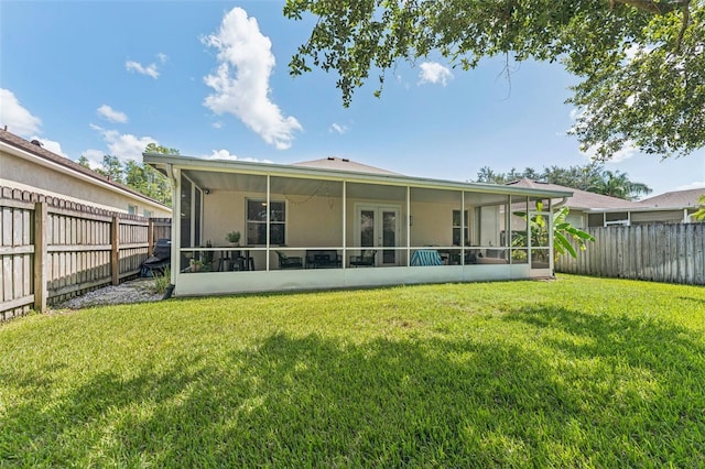 10409 Glen Willow Ln, Tampa, FL 33647 - rear view of property featuring a sunroom, a fenced backyard, and stucco siding