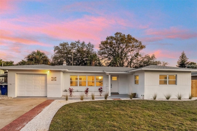 1320 Dixie Ln S, Saint Petersburg, FL 33707 - ranch-style house featuring a garage, concrete driveway, a yard, and stucco siding