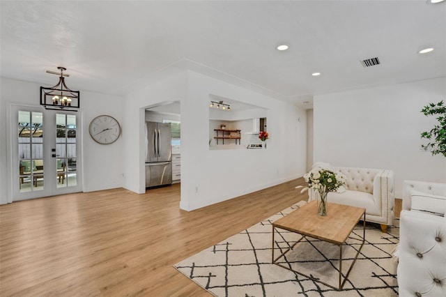 1320 Dixie Ln S, Saint Petersburg, FL 33707 - living room with a chandelier, light wood-style floors, plenty of natural light, and recessed lighting