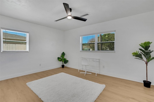 1320 Dixie Ln S, Saint Petersburg, FL 33707 - living area with healthy amount of natural light, light wood-style floors, and a ceiling fan