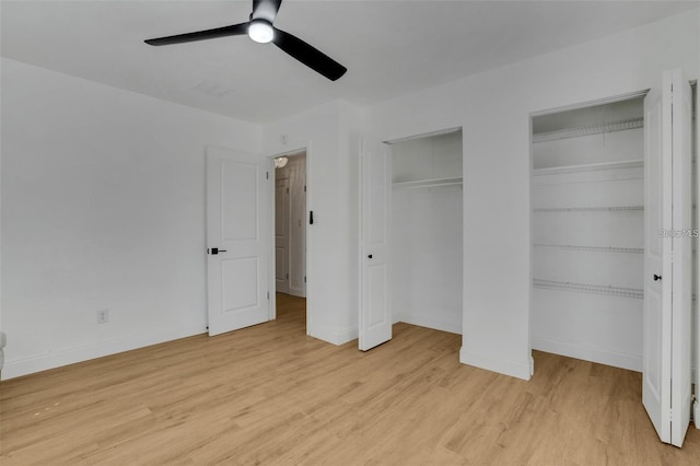 1320 Dixie Ln S, Saint Petersburg, FL 33707 - unfurnished bedroom with two closets, light wood-style flooring, and ceiling fan