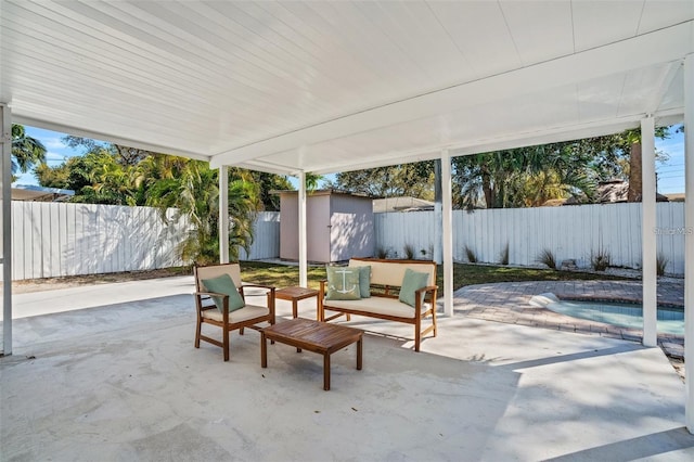 1320 Dixie Ln S, Saint Petersburg, FL 33707 - fenced backyard featuring a patio, a storage unit, a jacuzzi, and outdoor lounge area