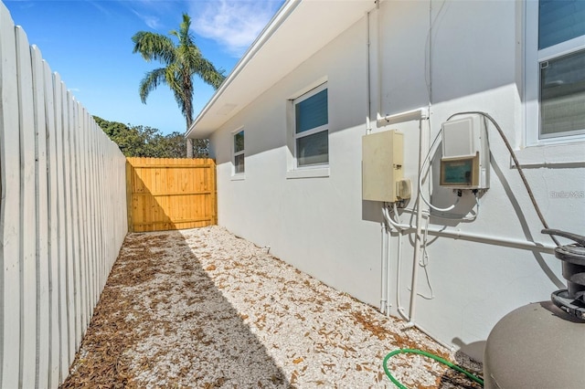 1320 Dixie Ln S, Saint Petersburg, FL 33707 - view of home's exterior with stucco siding and a gate