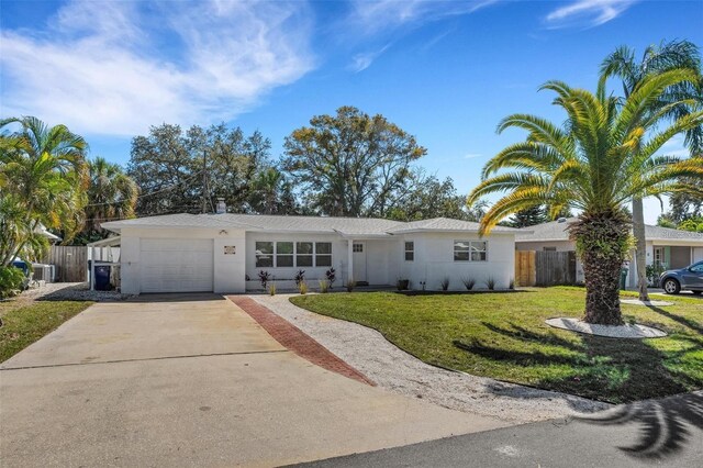 1320 Dixie Ln S, Saint Petersburg, FL 33707 - single story home featuring a garage, driveway, and stucco siding