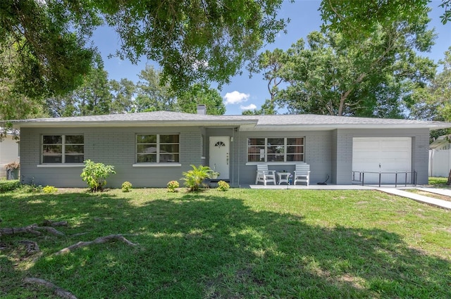 4917 99th St N, Saint Petersburg, FL 33708 - ranch-style home with an attached garage, brick siding, a front yard, and a chimney