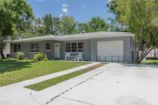 4917 99th St N, Saint Petersburg, FL 33708 - ranch-style house featuring an attached garage, driveway, a front yard, brick siding, and a chimney