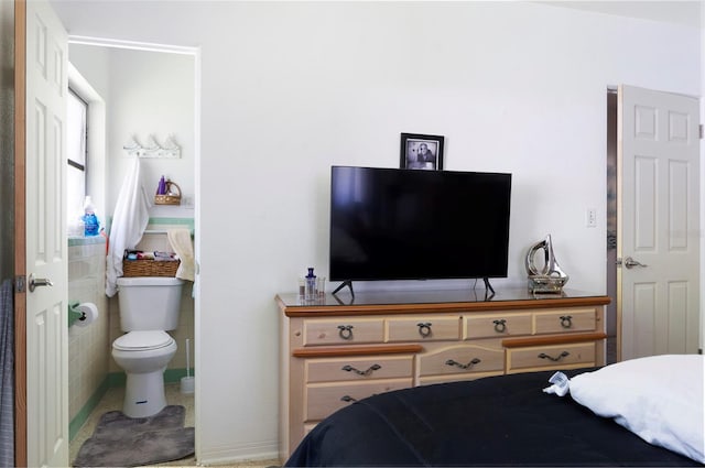 4917 99th St N, Saint Petersburg, FL 33708 - bedroom with ensuite bathroom and tile walls