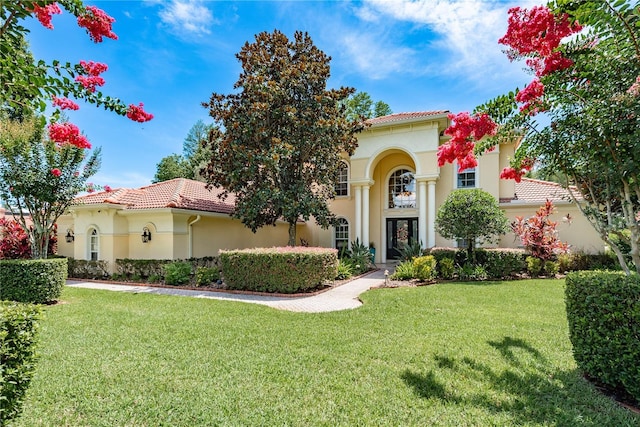 3042 Wentworth Way, Tarpon Springs, FL 34688 - mediterranean / spanish home featuring stucco siding, a tile roof, and a front yard