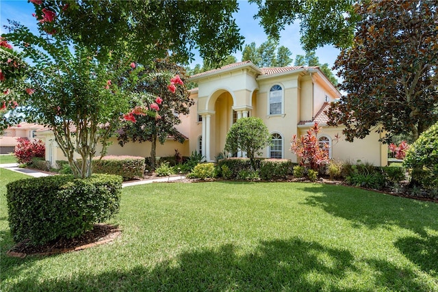 3042 Wentworth Way, Tarpon Springs, FL 34688 - mediterranean / spanish-style house with stucco siding and a front lawn
