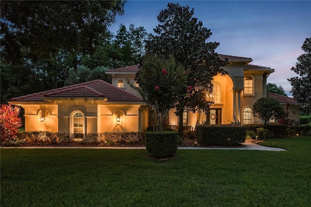 3042 Wentworth Way, Tarpon Springs, FL 34688 - mediterranean / spanish house featuring a tiled roof, a front yard, and stucco siding