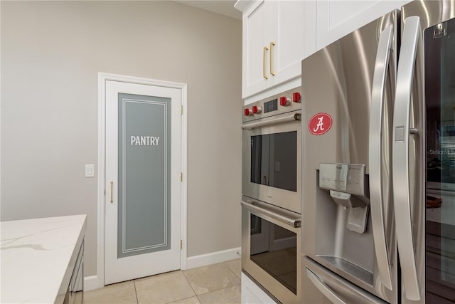 3042 Wentworth Way, Tarpon Springs, FL 34688 - kitchen featuring stainless steel appliances, light tile patterned floors, light stone countertops, and white cabinetry