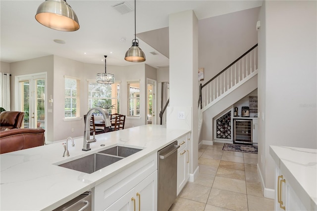 3042 Wentworth Way, Tarpon Springs, FL 34688 - kitchen with wine cooler, stainless steel dishwasher, light stone countertops, white cabinetry, and pendant lighting