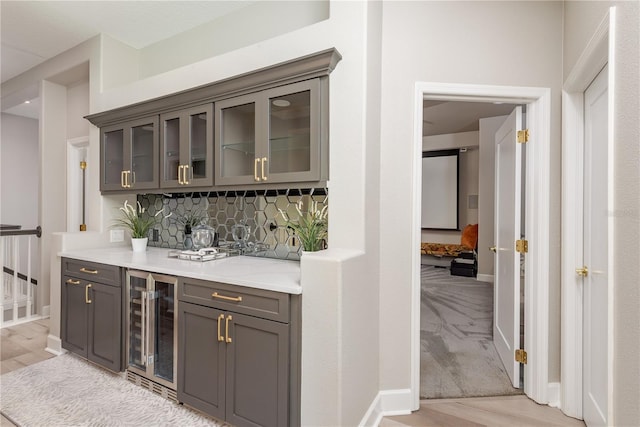 3042 Wentworth Way, Tarpon Springs, FL 34688 - bar with wine cooler, backsplash, and light wood-type flooring