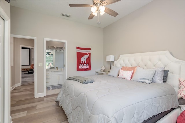 3042 Wentworth Way, Tarpon Springs, FL 34688 - bedroom featuring light wood-style flooring, vaulted ceiling, a ceiling fan, and ensuite bathroom