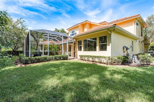 3042 Wentworth Way, Tarpon Springs, FL 34688 - back of property featuring a tile roof, a yard, stucco siding, and glass enclosure
