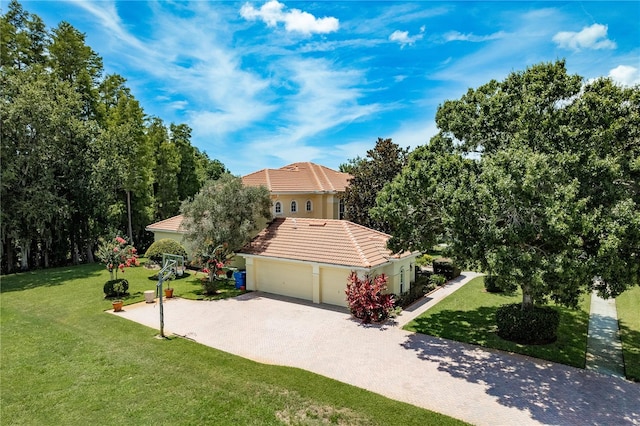3042 Wentworth Way, Tarpon Springs, FL 34688 - view of side of home featuring driveway, a tile roof, a yard, and stucco siding