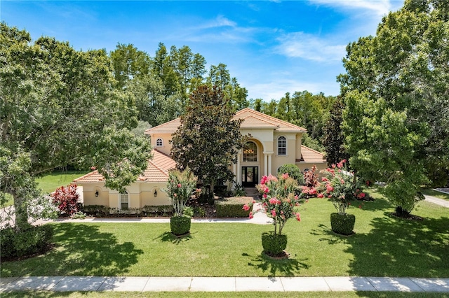 3042 Wentworth Way, Tarpon Springs, FL 34688 - mediterranean / spanish-style house with a tiled roof, stucco siding, and a front lawn