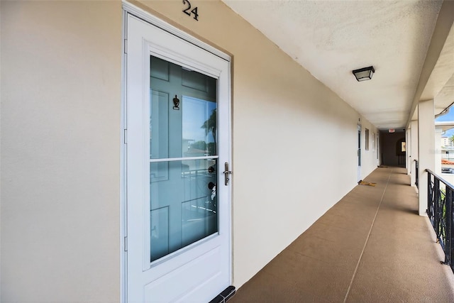 10351 Regal Dr Unit 24, Largo, FL 33774 - view of exterior entry with stucco siding and a balcony