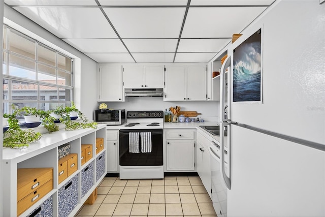 10351 Regal Dr Unit 24, Largo, FL 33774 - kitchen featuring white appliances, under cabinet range hood, open shelves, light tile patterned floors, and white cabinetry
