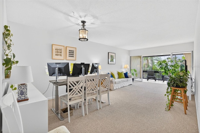 10351 Regal Dr Unit 24, Largo, FL 33774 - dining area featuring carpet floors, a desk, and a textured ceiling