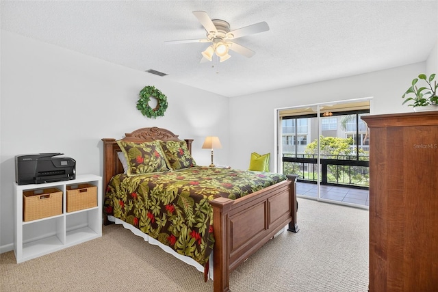 10351 Regal Dr Unit 24, Largo, FL 33774 - bedroom with access to exterior, light colored carpet, a ceiling fan, and a textured ceiling